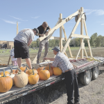 Pumpkin flingers (l-r) Kade Baxendale, Howard Asay and Rod Workman load Baxendale’s trebuchet during the Punkin Chunkin demonstration at the Lovell Middle School field Saturday afternoon. Organizers hope the event will grow into a competition next year. David Peck