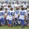 Lovell coaches (l-r) Bill Scheckler, Michael Jameson (behind), Nicc Crosby,  Greg Rael, Logan Blau and Bob Weber speak to the team at halftime against Buffalo on Saturday. Bulletin photo by Joseph Ciembroniewicz