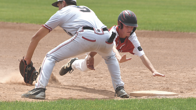 Lovell Mustang Aaiden Walker dives back into first base during a pickoff move in Lovell’s 8-3 game one win over the Riverton Raiders Saturday. The Mustangs face Wheatland today (Thursday) at 1 p.m. at the state tournament in Green River. David Peck