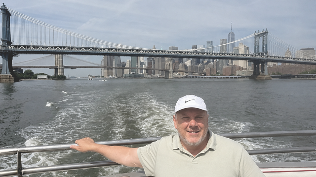 The author enjoys the iconic view of the Manhattan Bridge, Brooklyn Bridge, and Lower Manhattan skyline.