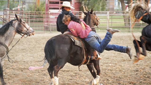 Pick-up man Quinn Larsen of Deaver rescues Monte Blank of Lovell during the ranch bronc event Friday night at the Big Horn County Fair Rodeo in Basin. Blank scored 68 on his ride to claim third place. Lisa Kunkel