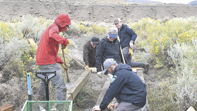 BLM employees work on making an ADA accessible trail on Public Lands Day Saturday at Rainbow Canyon Interpretive Site. Pictured are (l-r) Anthony Camiccia, Abel Guevara, Camille Scott, Zach Cowfer with Rick Tryder in the foreground.  Sherry Snell