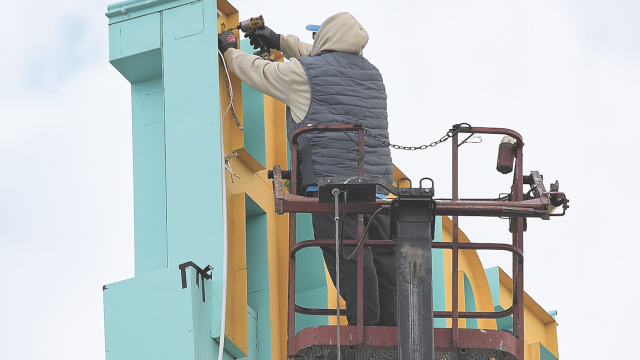 An employee of Epcon Sign Group installs LED lighting on the Hyart Theatre sign last week. The iconic sign will soon light up the night on Lovell’s Main Street once again. David Peck